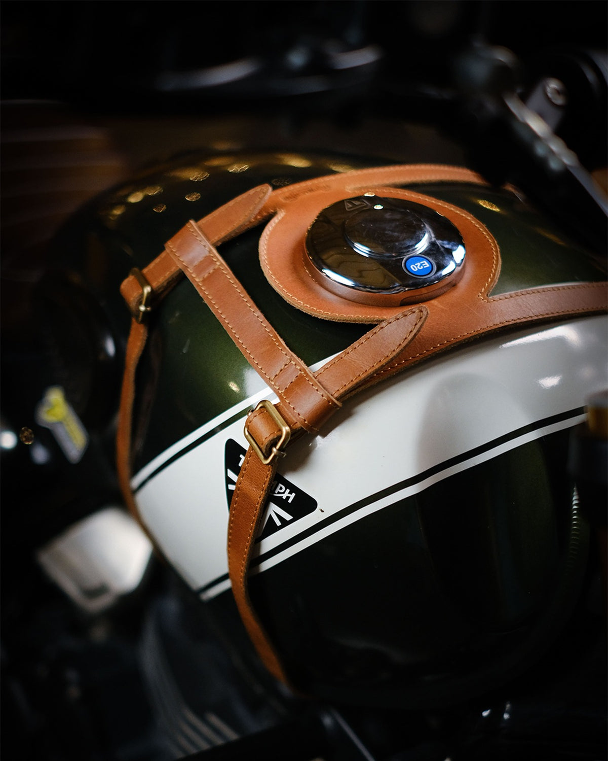 Close-up of a motorcyclefuel tank strap on a blurred background