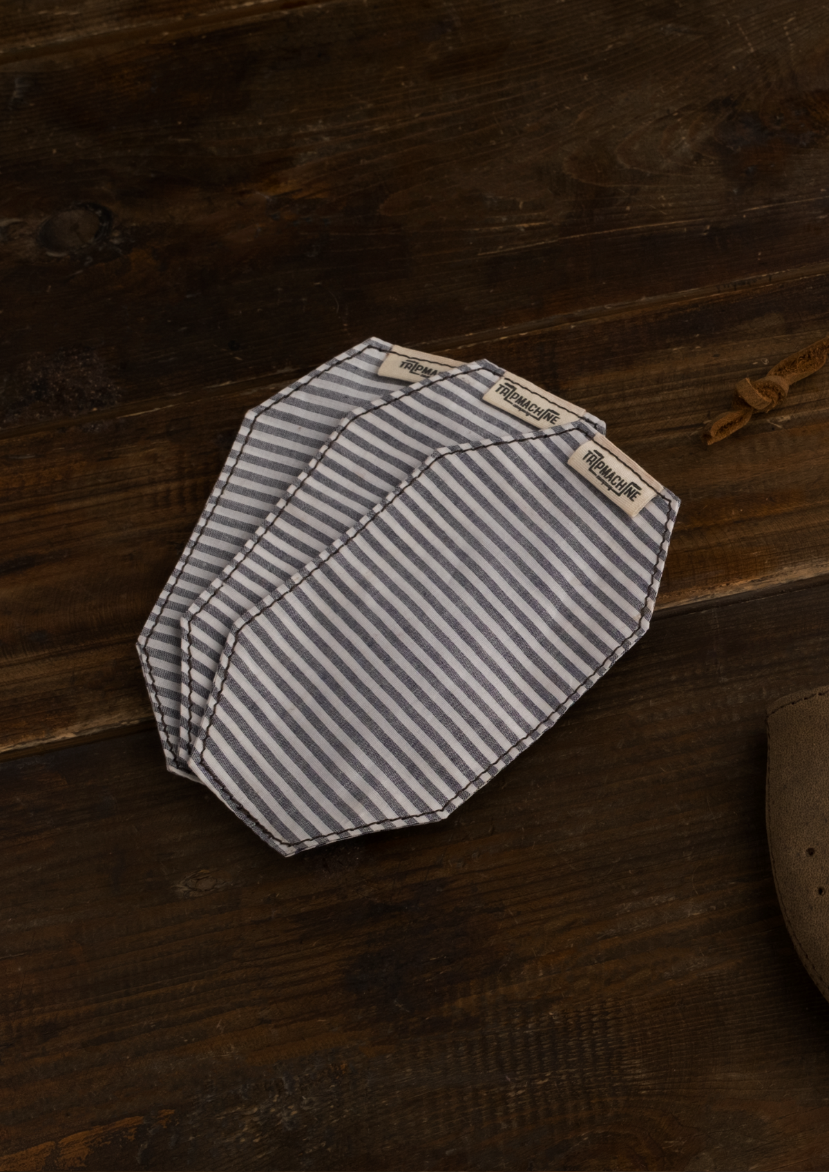 A pack of three striped face mask replacement filters in blue and white color.