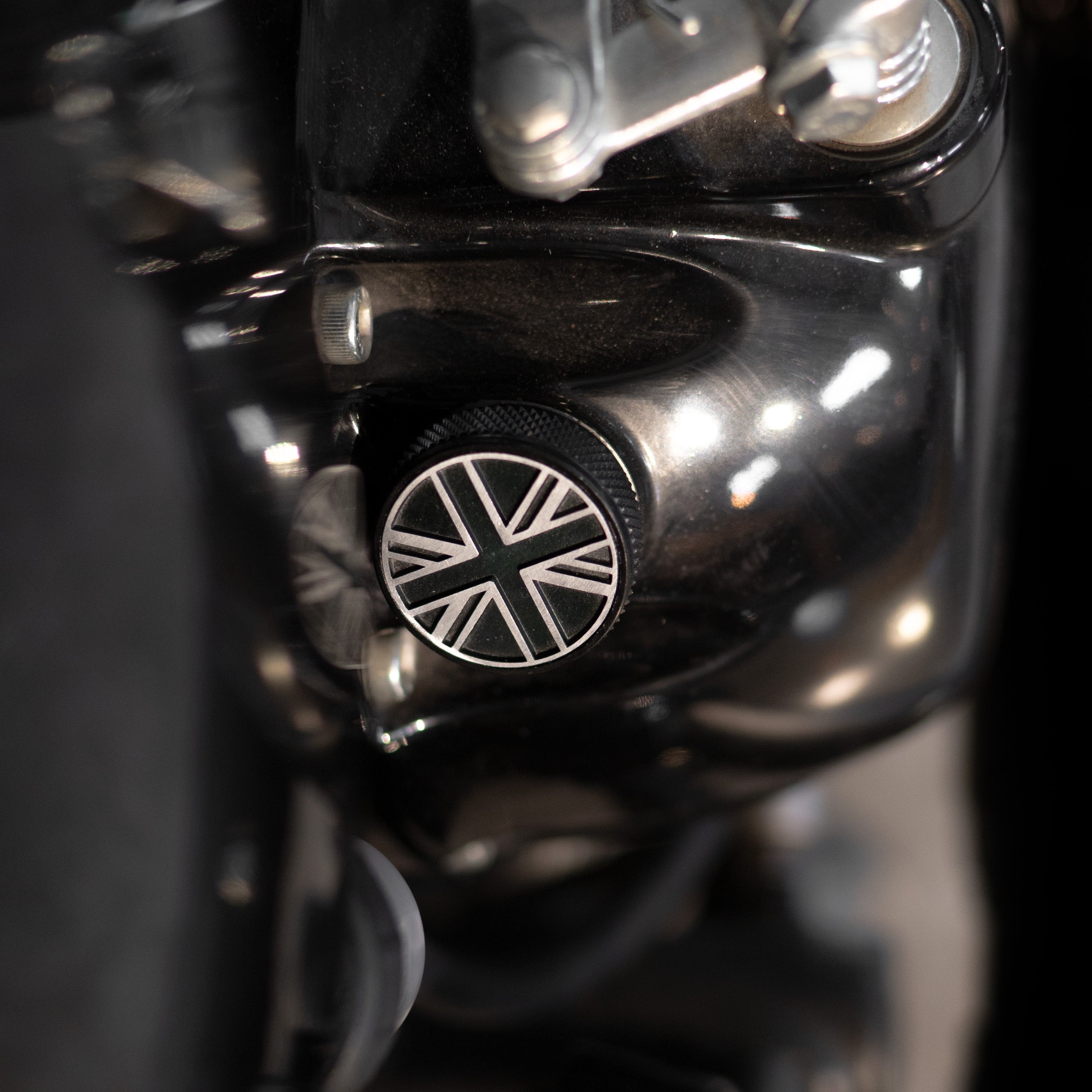 Close-up of a motorcycle engine with a Union Jack emblem oil filler cap