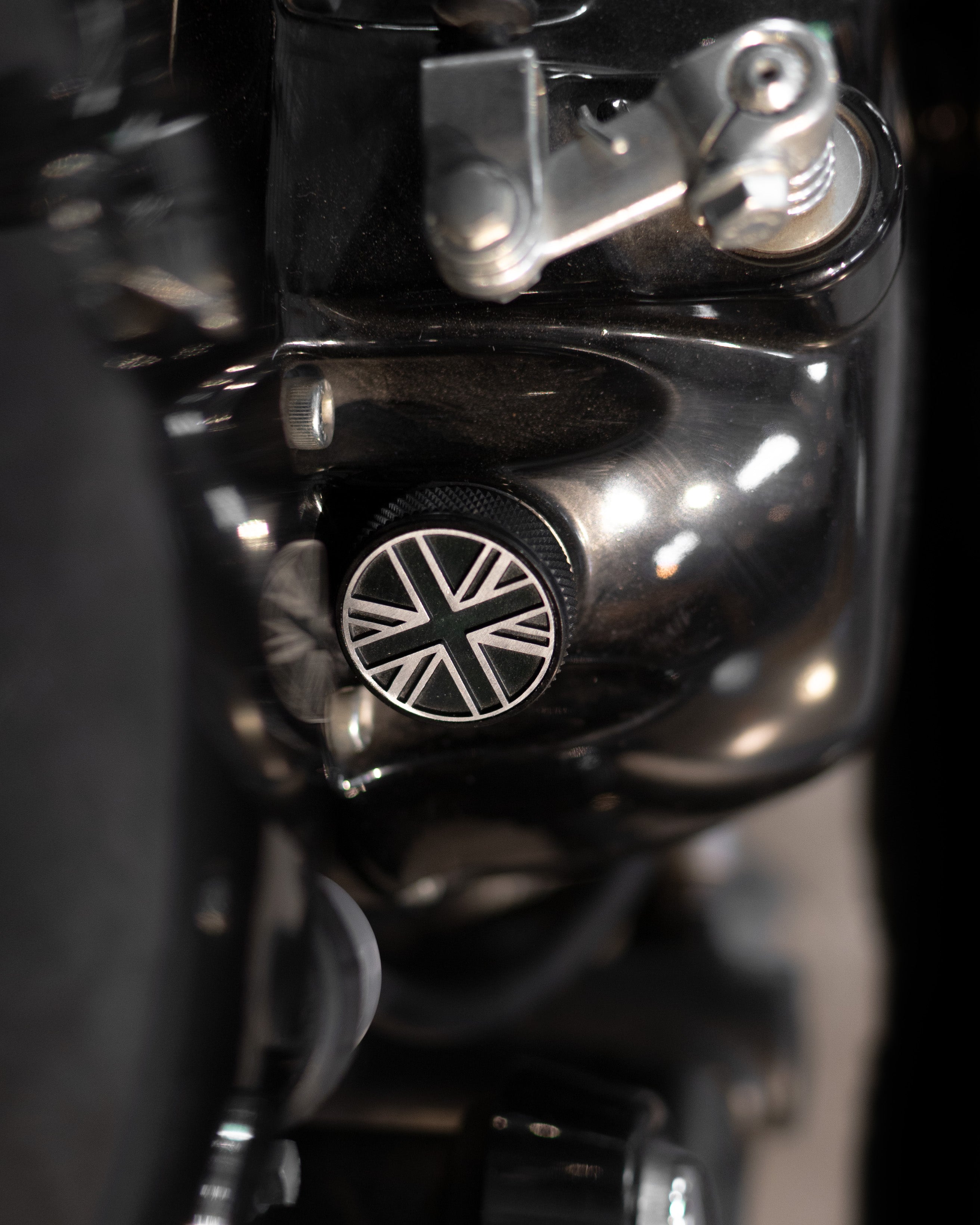 Close-up of a motorcycle engine with a Union Jack emblem oil filler cap
