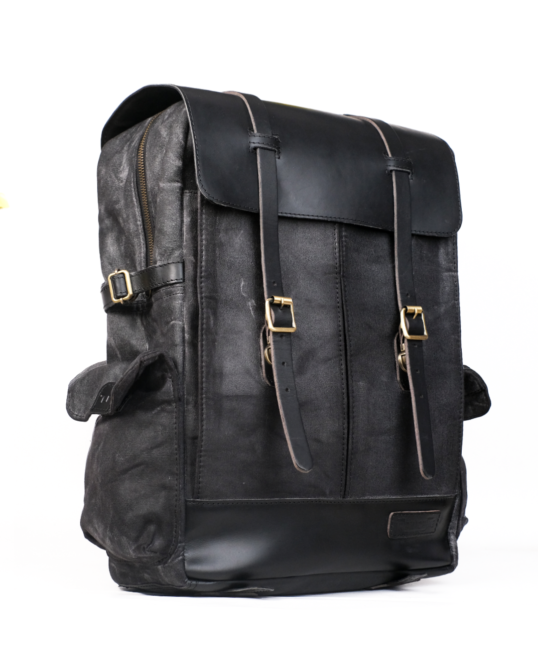 Black leather backpack with gold buckles on a white background