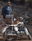 Man standing next to a motorcycle with a saddlebag in a natural setting