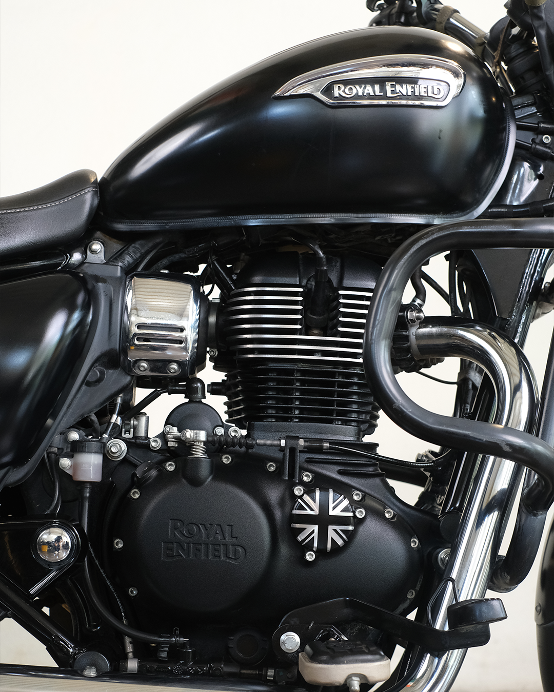 Close-up of a Royal Enfield motorcycle engine with the brand logo visible.