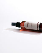 Bottle of leather cleaner with a white label on a white background