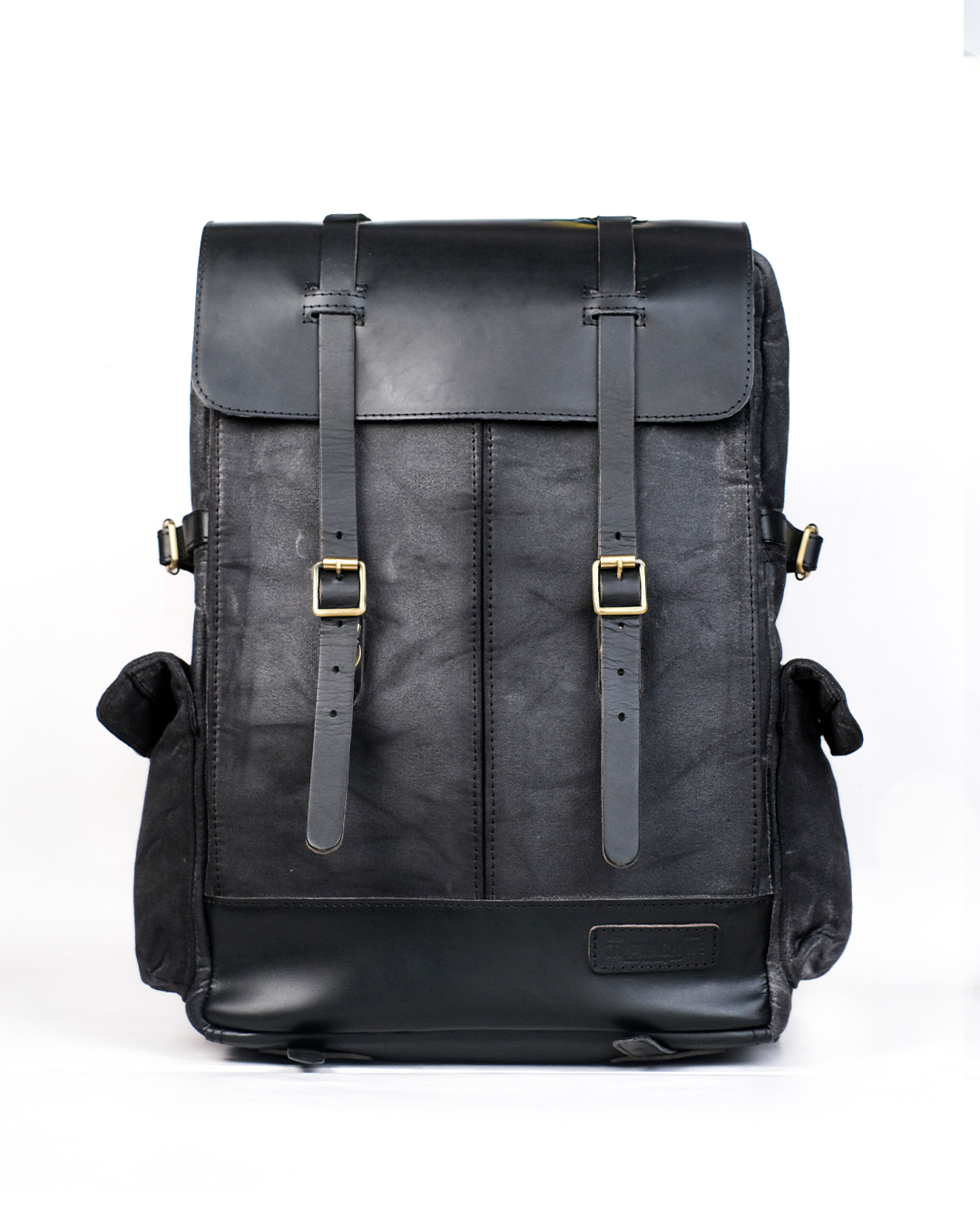 Black leather backpack with gold buckles on a white background