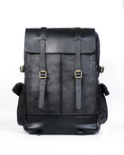 Black leather backpack with gold buckles on a white background