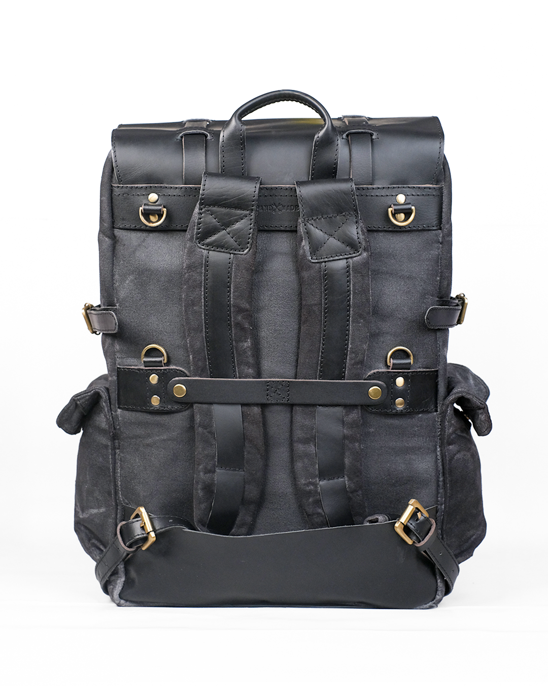 Black leather backpack with gold buckles on a white background
