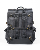 Black leather backpack with gold buckles on a white background