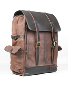 Brown leather backpack with black accents on a white background